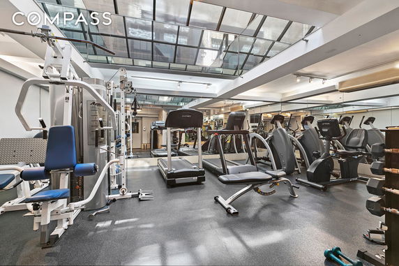 Indoor gym with various exercise machines and equipment.
