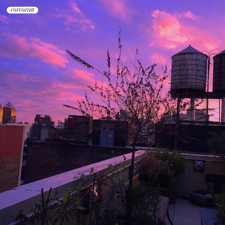 Rooftop view with water towers and evening sky.