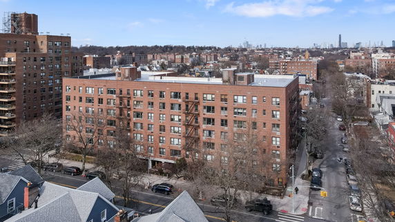Front view of a multi-story apartment building in an urban area.