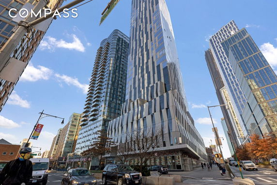 Front view of a modern high-rise building with glass facade.