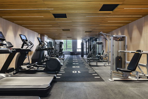 Interior view of a modern gym with exercise equipment.