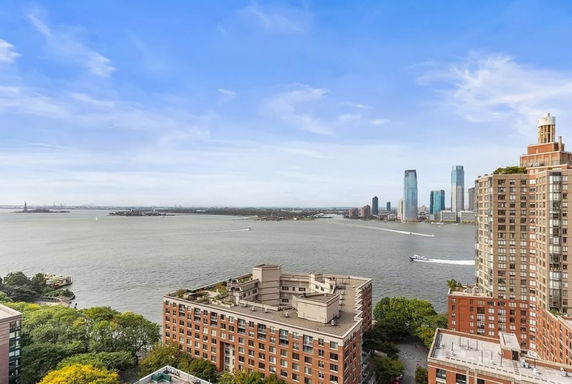 Wide angle view from building showing river, distant cityscape, and skyline.
