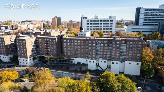 Front view of a large multi-story residential building with multiple windows and balconies.