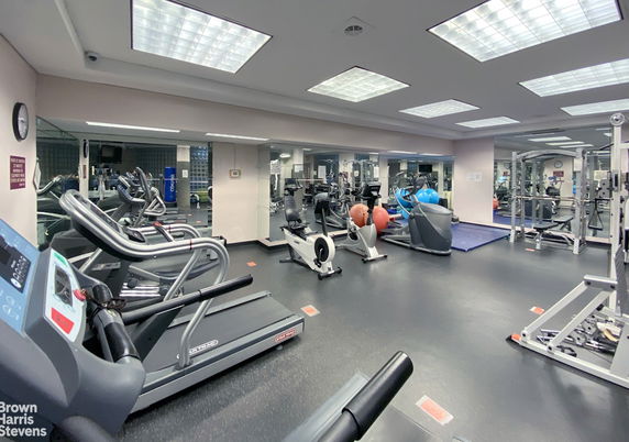 Indoor gym area with various exercise equipment.