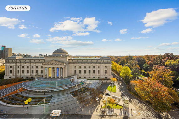 Front view of a large classical-style building with a domed roof and pillars.