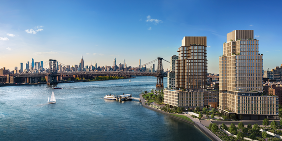 View of a bridge and city skyline with modern buildings alongside a river.