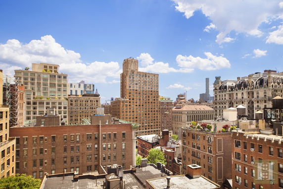 View of a cityscape with multiple buildings and a clear sky.
