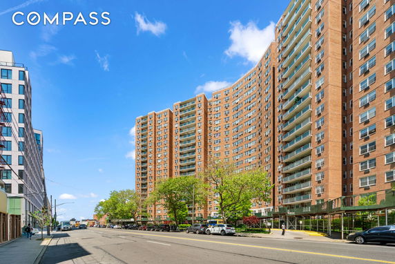 Front view of a multi-story apartment building with balconies