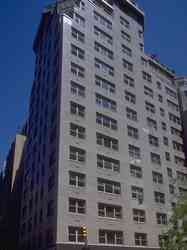 Front view of a multi-story building with numerous windows.