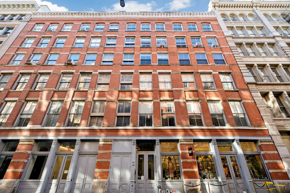 Front view of a multi-story building with a brick facade.