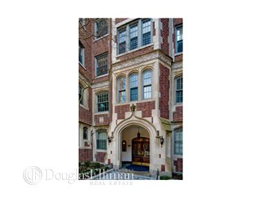 Front view of a multi-story brick building with arched entrance.