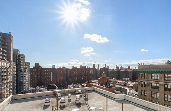 Rooftop view with utility structures on a sunny day