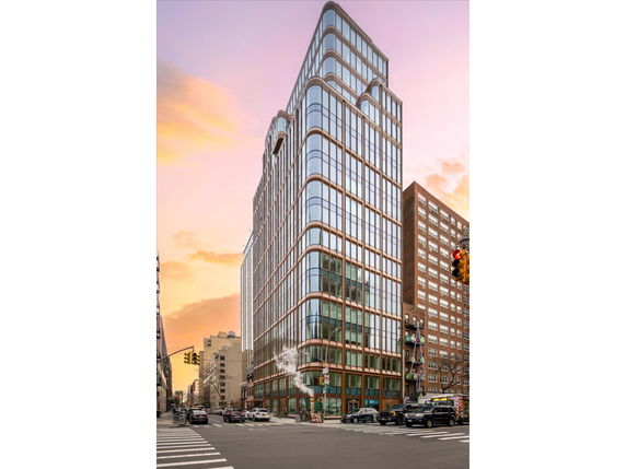 Front view of a multi-story modern building with glass facade.