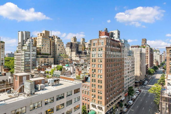 Panoramic view of a cityscape with high-rise buildings and a clear blue sky.