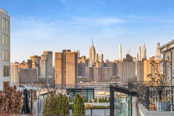 View of surrounding cityscape with tall buildings.