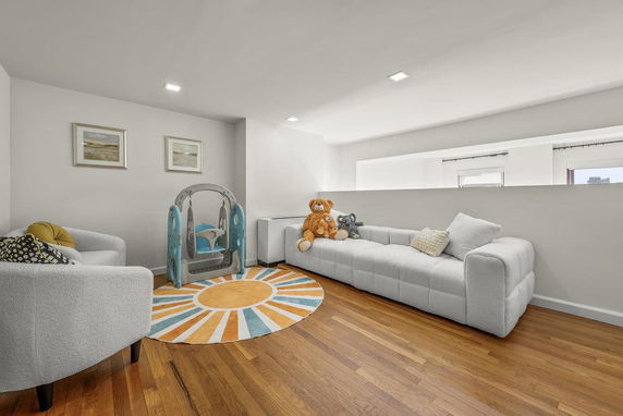 Room with a playpen and a couch for children's play.