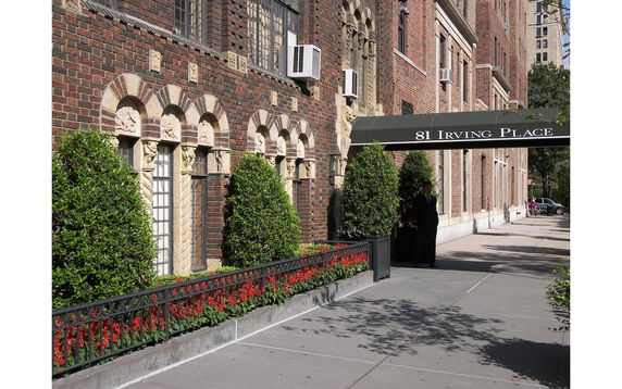 Front view of a brick building with decorative arches and a canopy reading '81 Irving Place'.