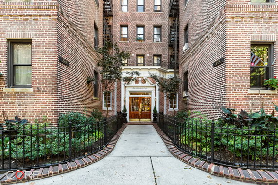 Front view of a brick apartment building entrance.