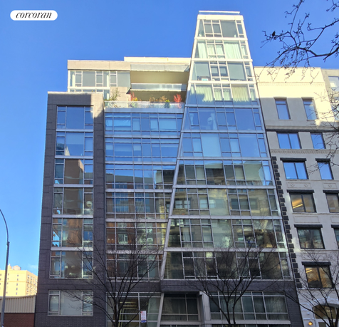 Front view of a modern multi-story building with glass façade.
