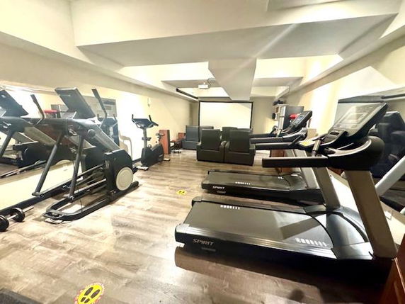 Indoor gym area with treadmills and exercise equipment.