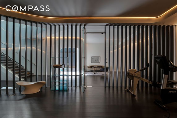 Modern indoor recreational area with exercise equipment and contemporary seating.