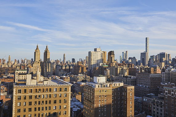 Panoramic view of a city skyline with multiple skyscrapers and buildings.