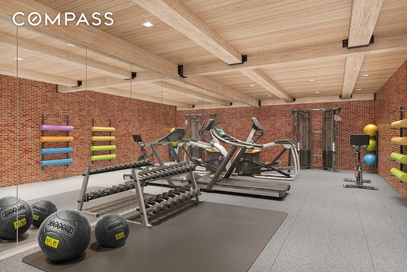 Indoor gym area with various fitness equipment.