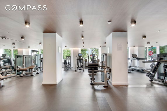 Interior view of a well-equipped gym area with exercise machines and equipment.