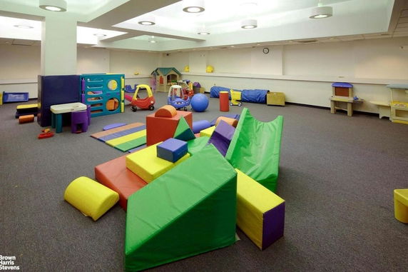 Indoor children's play area with colorful play equipment and toys.