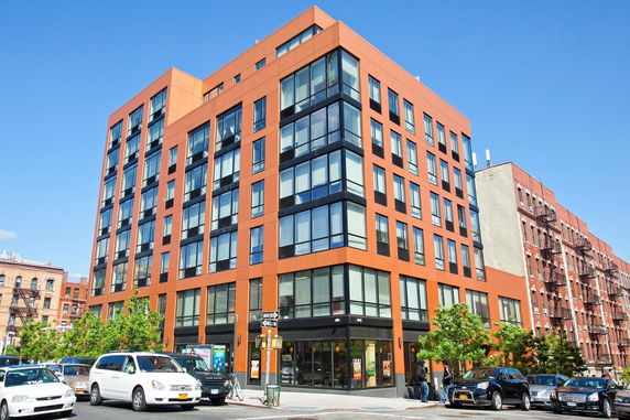 Front view of a modern multi-story building with large windows.