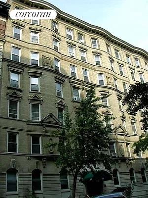 Front view of a multi-story residential building with multiple windows.