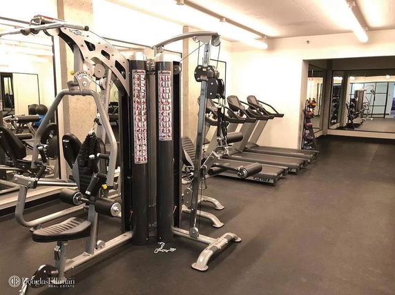 Gym area with exercise machines and treadmills.