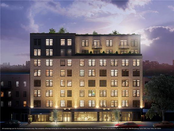 Front view of a multi-story building with illuminated facade.