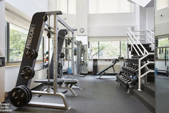 Indoor gym area with exercise equipment and weights