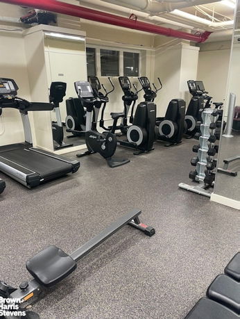 Indoor gym area with exercise equipment.