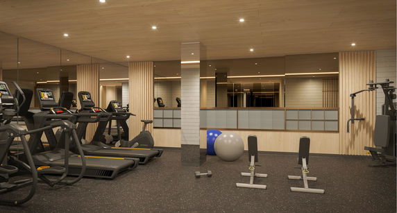 Interior view of a gym with treadmills, exercise equipment, and mirrored walls.