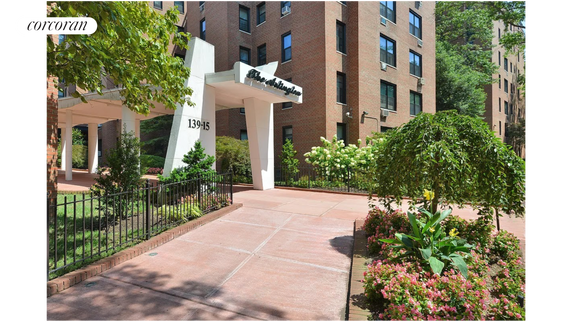 Front view of a multi-story brick building with an entrance canopy.