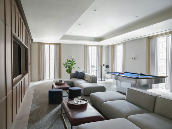 Room with modern seating, a pool table, and entertainment area.
