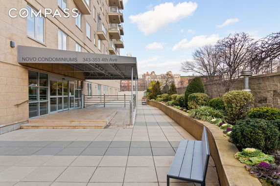 Front view of a multi-story condominium building with an entrance canopy.