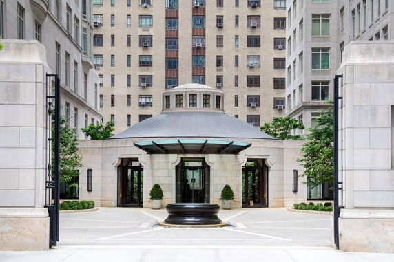 Front view of a building entrance with a circular design and glass canopy.