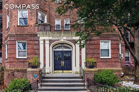 Front view of a brick building with a central entryway labeled as Riverdale House.