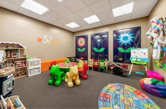 Indoor children's play area with colorful furniture and educational toys.