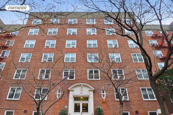 Front view of a multi-story brick apartment building.