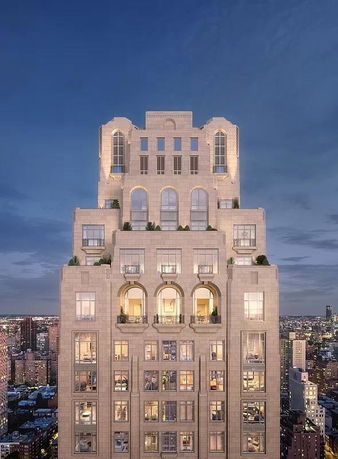 Front view of a tall, multi-story building with an intricate facade and multiple balconies.