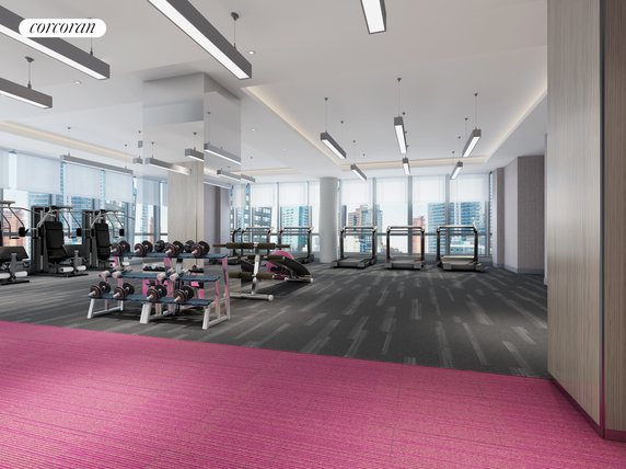Interior view of a modern gym with exercise equipment and large windows.