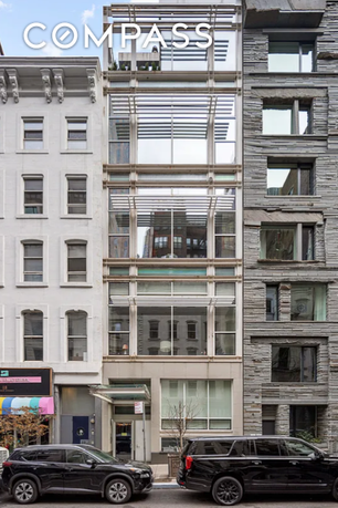Front view of a multi-story building with a modern glass facade.