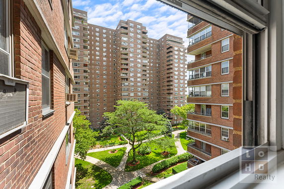 Front view of a multi-story building with numerous balconies.