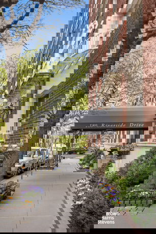 Front view of a multi-story building with entrance and signage.