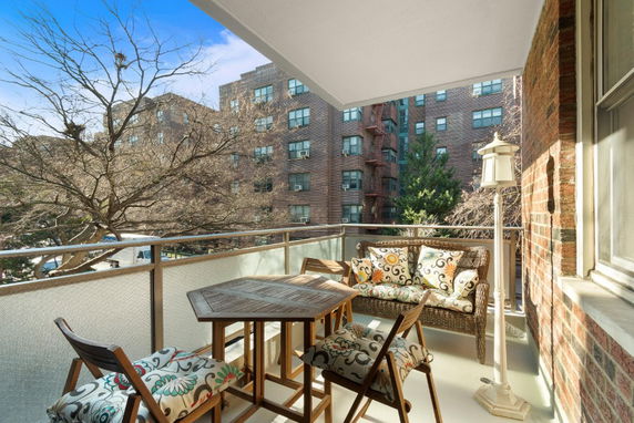 Balcony view of residential buildings with outdoor furniture.