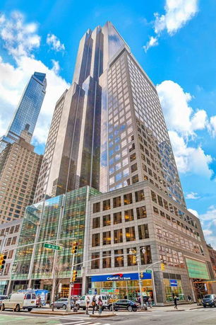 Front view of a modern high-rise building in an urban area.